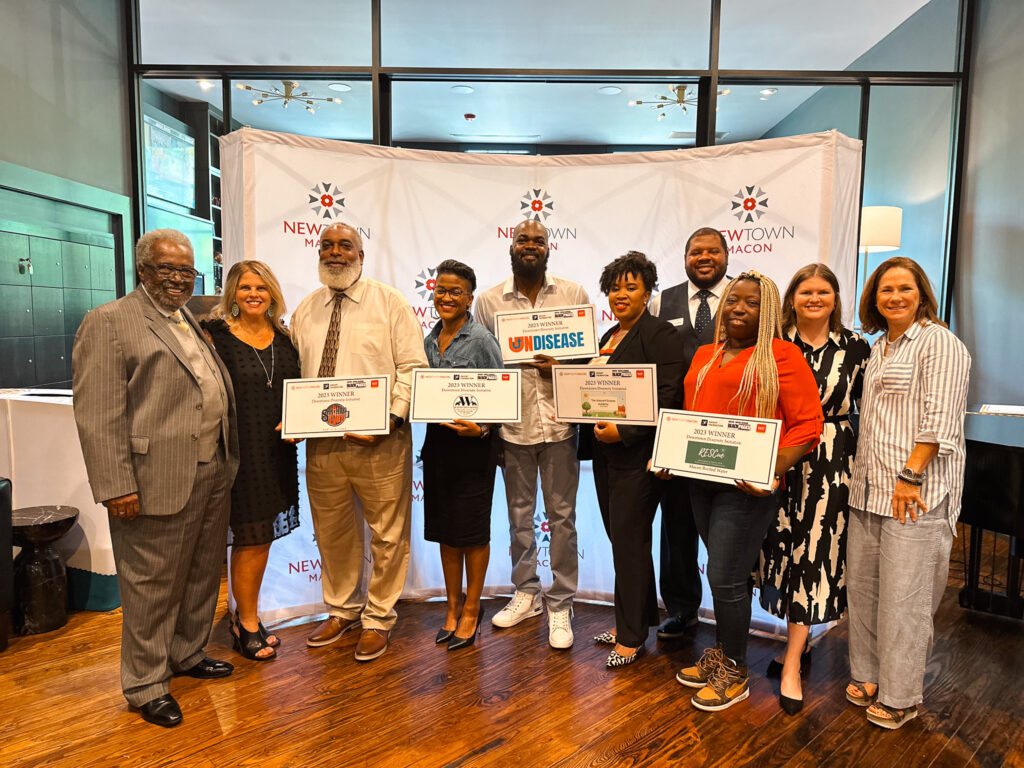 DDI graduates smile in group photo with diplomas in hand