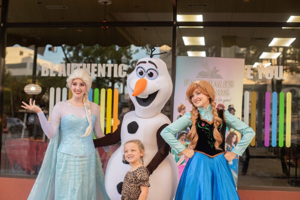 Characters pose with child in downtown macon